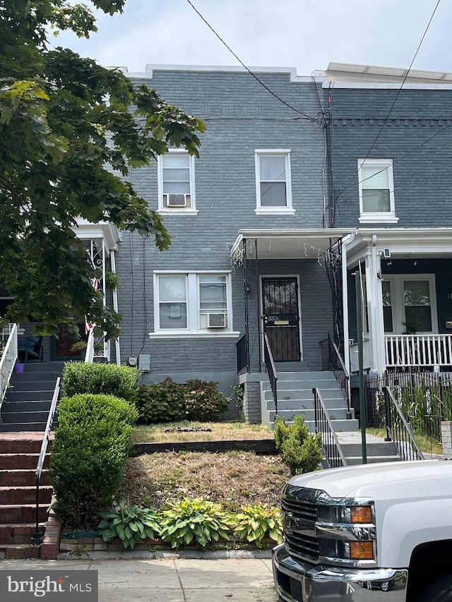townhome / multi-family property with brick siding and stairs