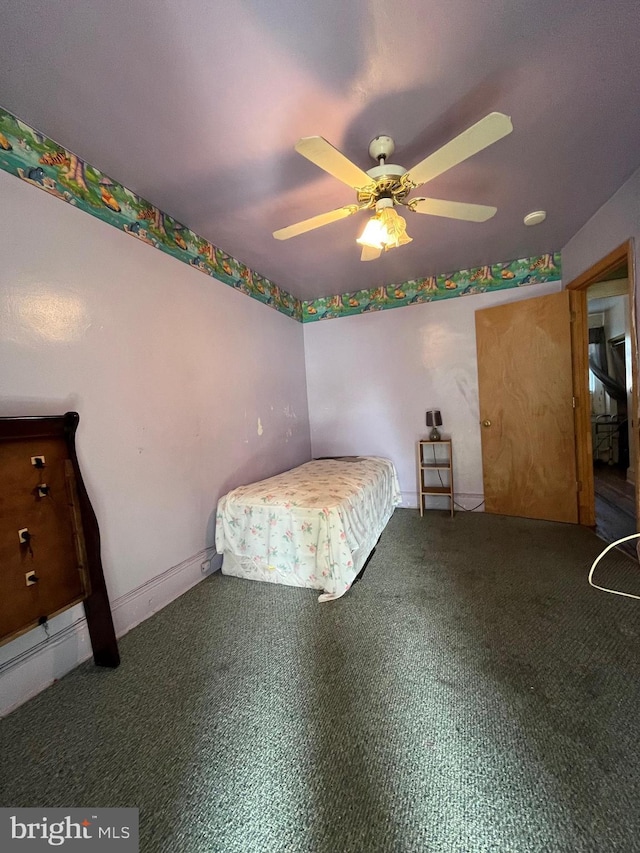 unfurnished bedroom featuring ceiling fan and carpet floors