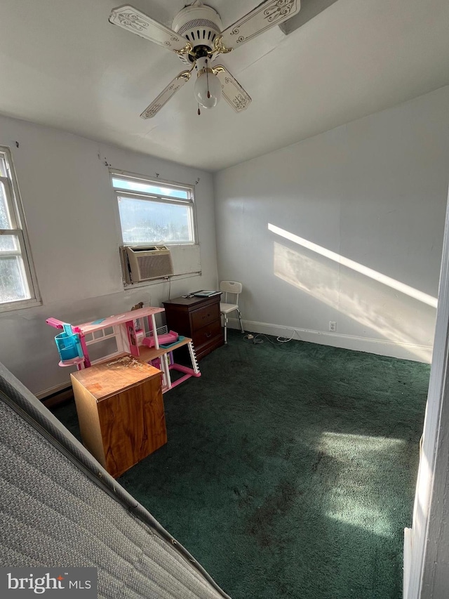 interior space featuring ceiling fan, cooling unit, and dark colored carpet