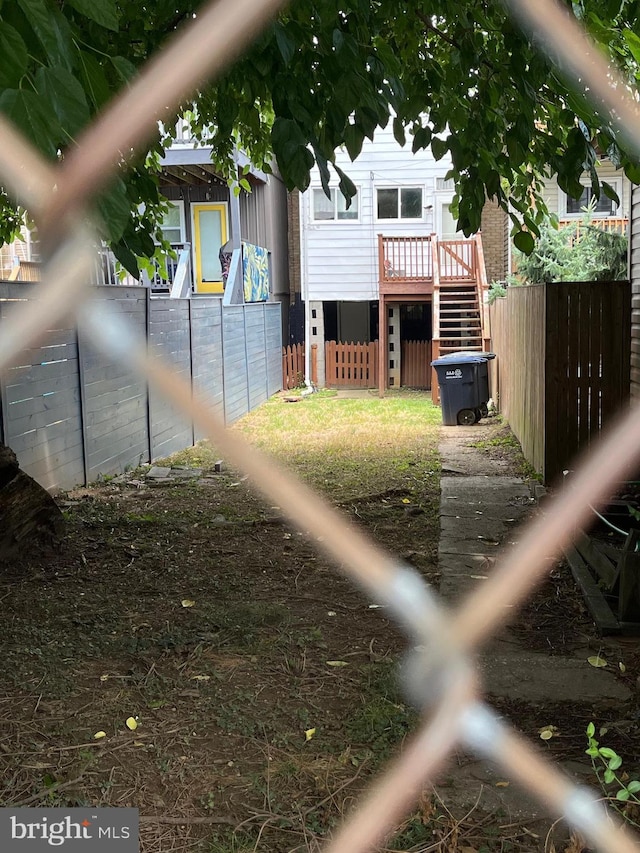 exterior space featuring stairs, a deck, and fence private yard