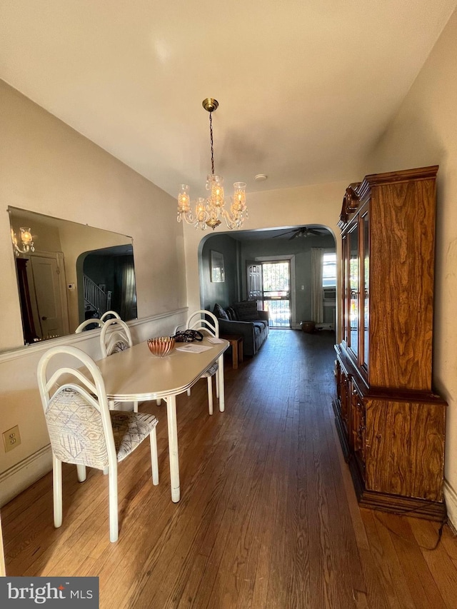 dining area featuring a chandelier and dark wood-type flooring