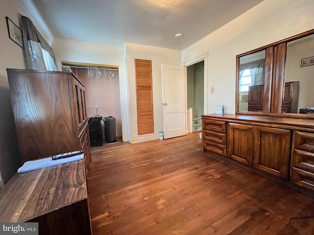 bedroom featuring a closet and dark hardwood / wood-style flooring