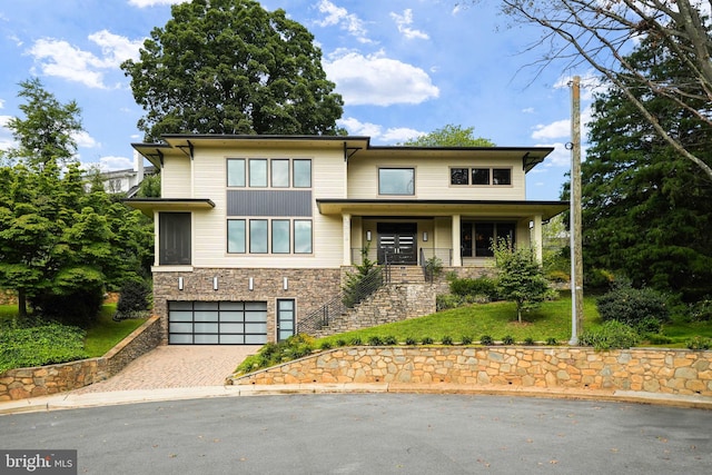 view of front facade with covered porch and a garage