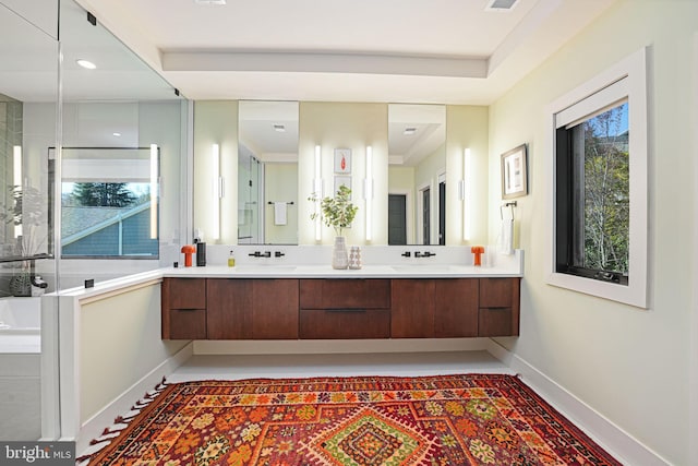 full bath with double vanity, visible vents, baseboards, and a sink