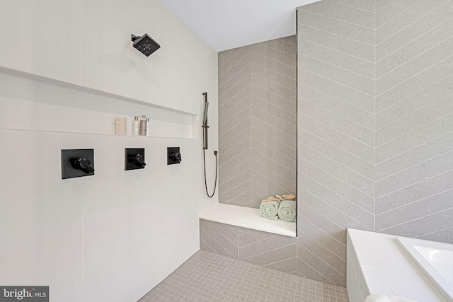 bathroom with tile patterned flooring, walk in shower, and tile walls