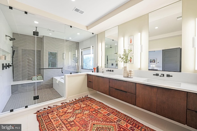 bathroom featuring tile patterned flooring, visible vents, a shower stall, and double vanity