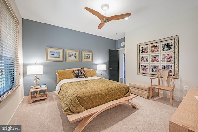 carpeted bedroom featuring visible vents, baseboards, and ceiling fan