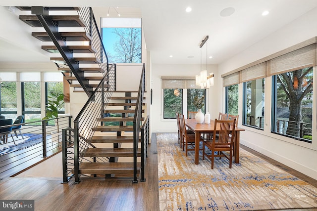 dining room with stairway, recessed lighting, baseboards, and wood finished floors