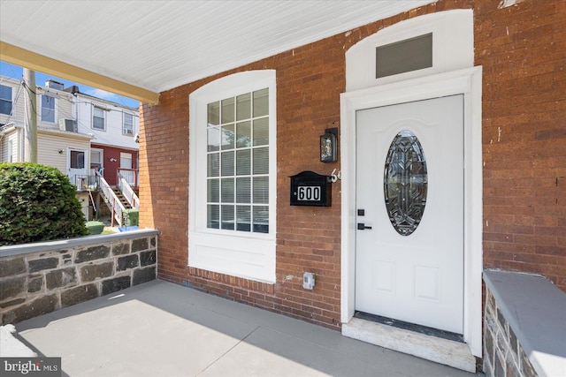 view of exterior entry with a porch