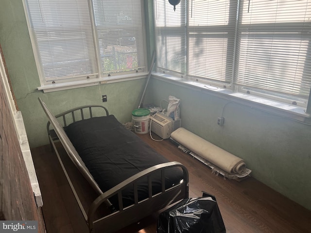 bedroom with dark wood-type flooring