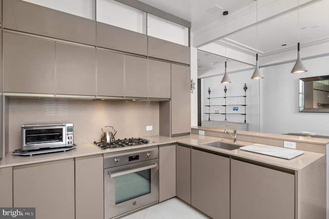 kitchen with gray cabinets, backsplash, stainless steel appliances, kitchen peninsula, and sink