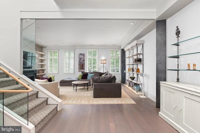 living room featuring hardwood / wood-style floors and built in shelves