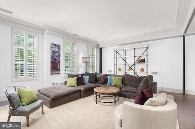 living room featuring plenty of natural light, ornamental molding, and hardwood / wood-style flooring