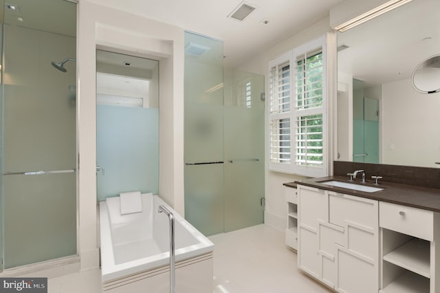 bathroom featuring vanity, independent shower and bath, and tile patterned flooring