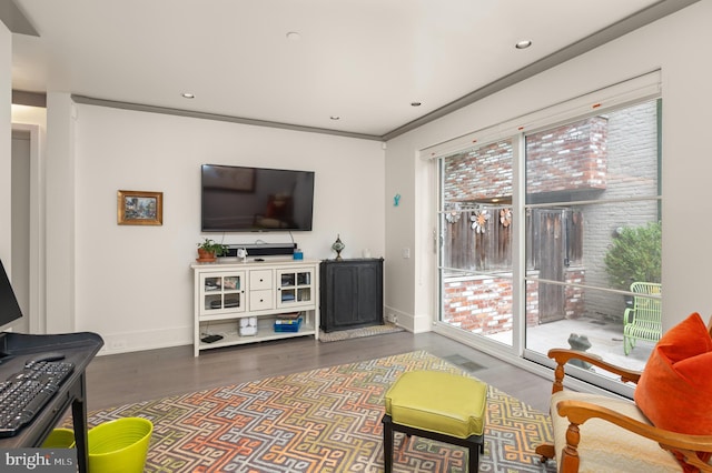 living room with crown molding and dark hardwood / wood-style floors