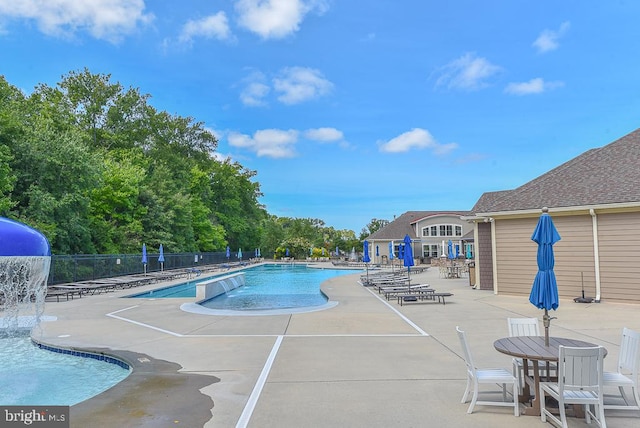 view of pool featuring pool water feature and a patio area