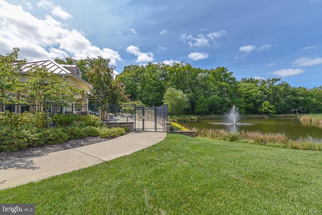 exterior space with a lawn and a water view