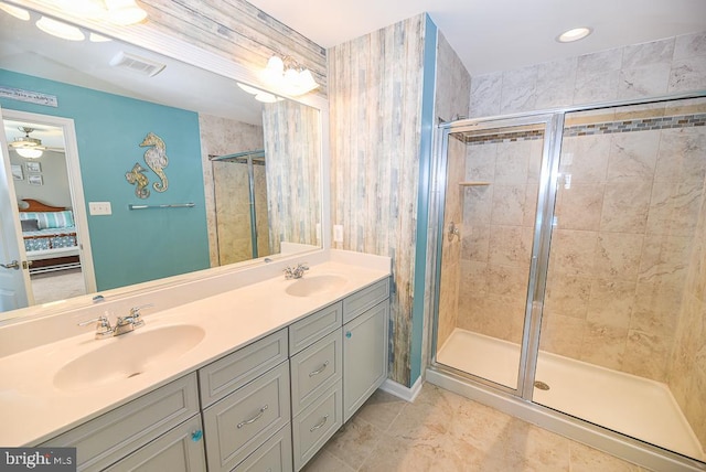 bathroom with vanity and a shower with door