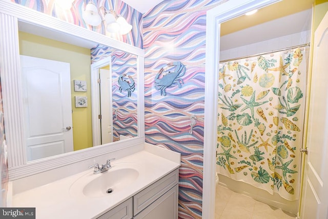 bathroom featuring vanity, shower / bath combo with shower curtain, and tile patterned floors