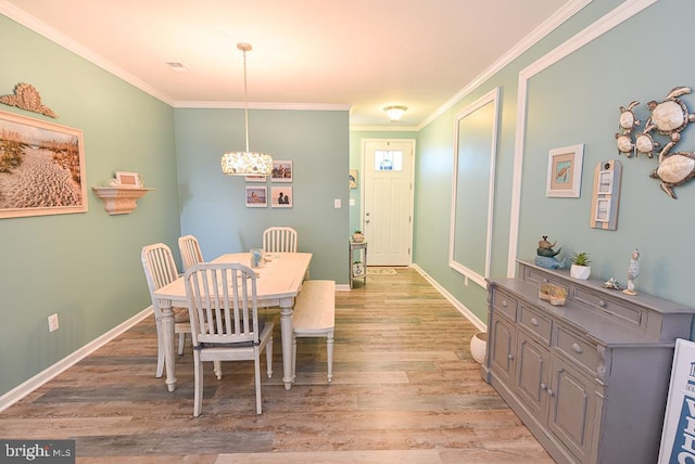 dining room featuring crown molding and wood-type flooring