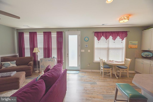 living room with ceiling fan and light hardwood / wood-style floors