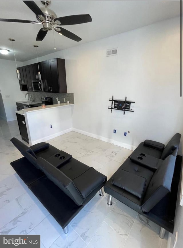 interior space with ceiling fan and sink