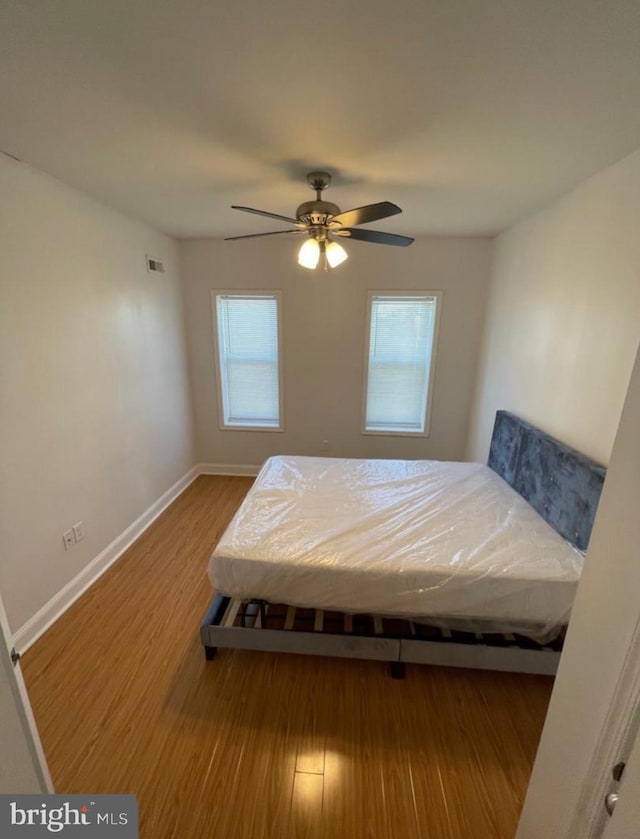 bedroom featuring hardwood / wood-style floors and ceiling fan