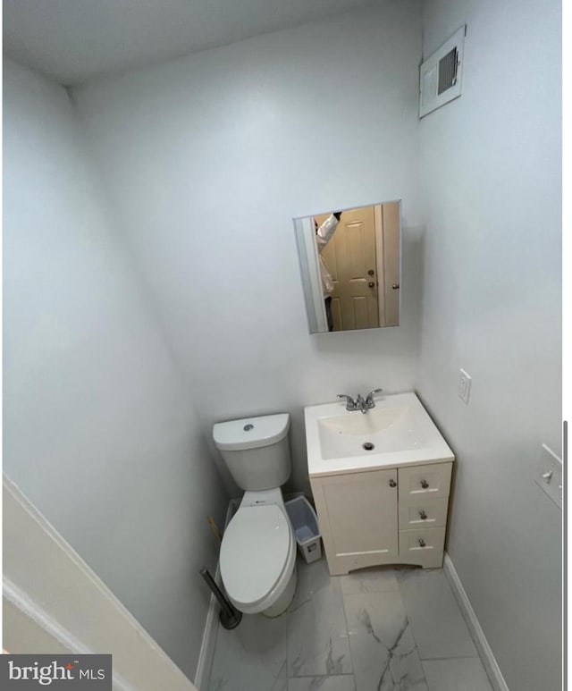 bathroom featuring toilet and vanity