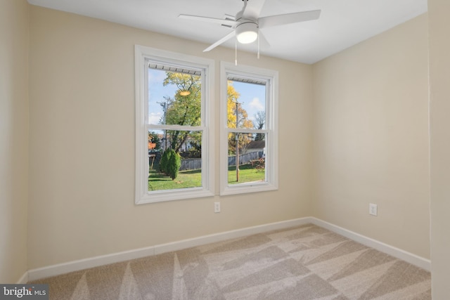 carpeted empty room featuring ceiling fan