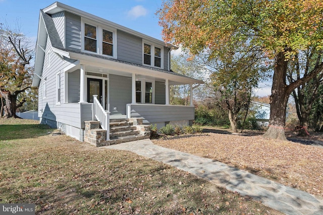 view of front of home with a front yard and a porch