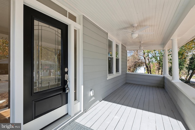 wooden deck with covered porch and ceiling fan