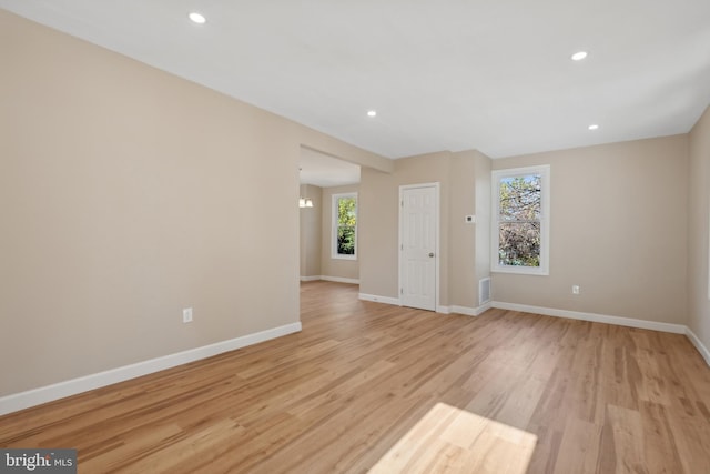 empty room with plenty of natural light and light wood-type flooring