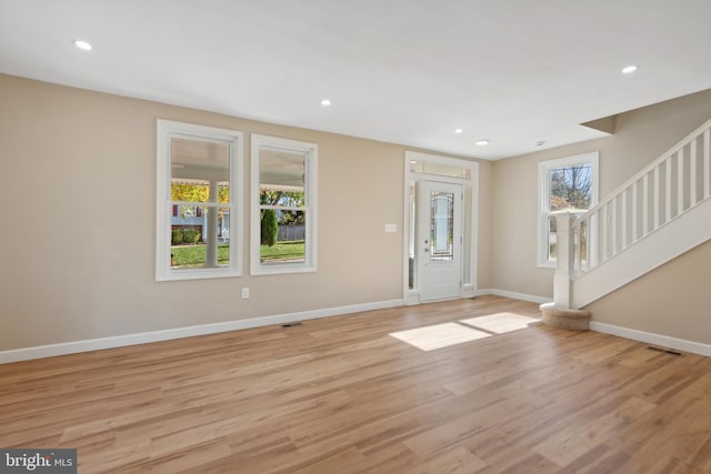 entrance foyer with light wood-type flooring and a wealth of natural light