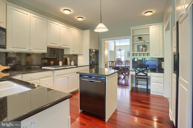 kitchen featuring dark wood-type flooring, black appliances, a center island, and white cabinets