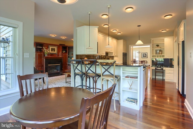 dining area featuring dark wood-type flooring