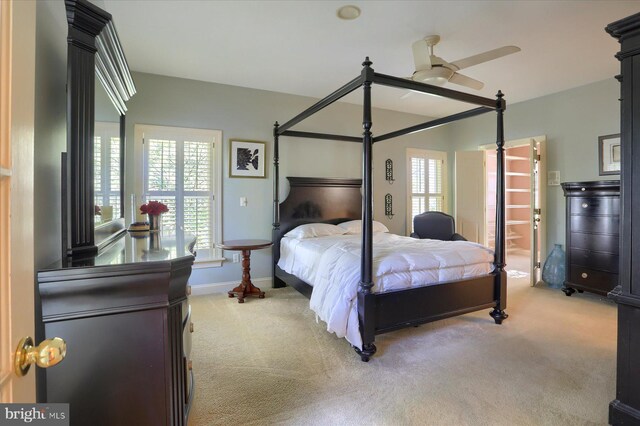 carpeted bedroom with ceiling fan and ensuite bath