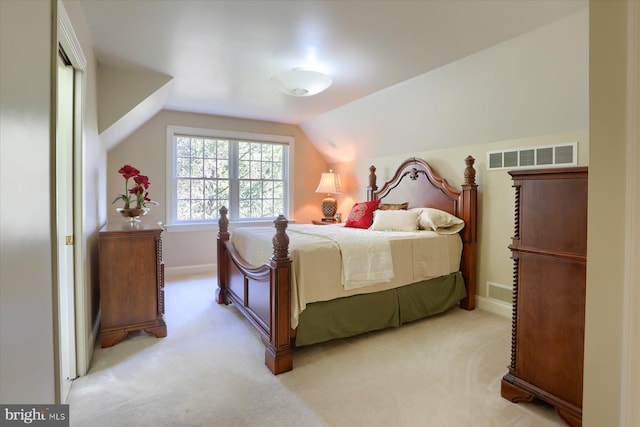 carpeted bedroom with lofted ceiling