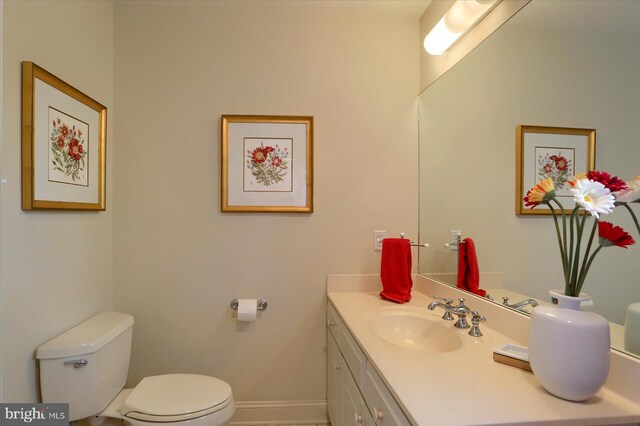 bathroom featuring toilet and vanity