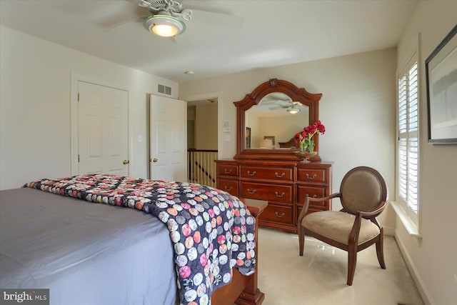 carpeted bedroom featuring multiple windows and ceiling fan