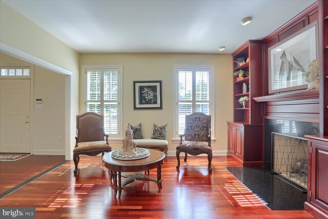 living area with a healthy amount of sunlight and dark wood-type flooring