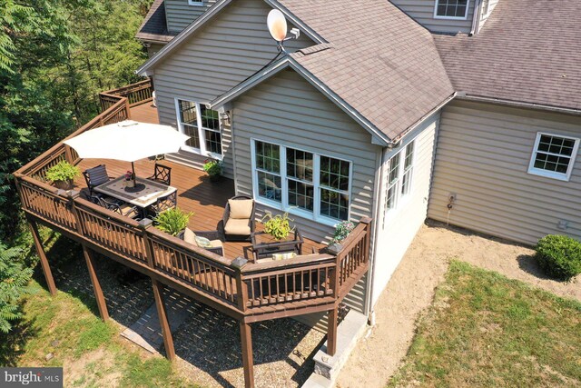 rear view of house with an outdoor living space and a wooden deck