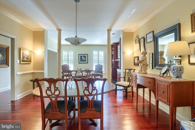 dining room featuring crown molding, dark wood-type flooring, and ornate columns