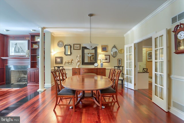 dining area with french doors, ornamental molding, dark hardwood / wood-style flooring, and decorative columns