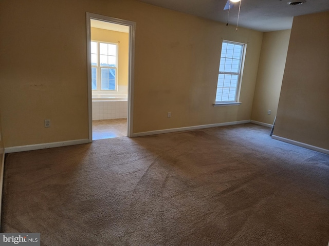 empty room featuring carpet and ceiling fan