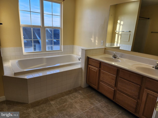 bathroom featuring tiled tub, tile patterned flooring, and vanity