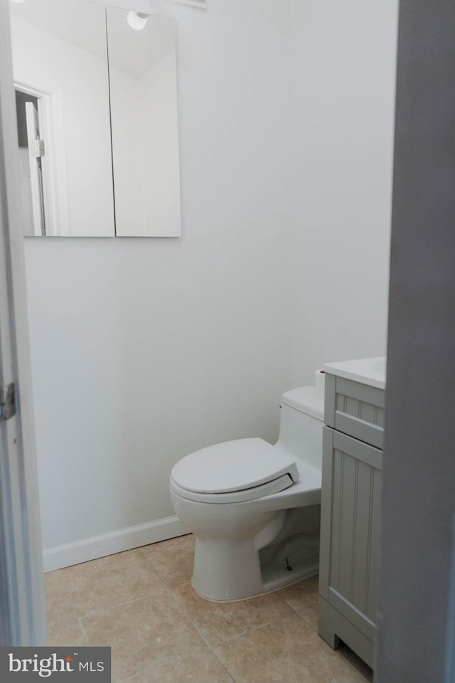 bathroom featuring vanity, toilet, and tile patterned floors