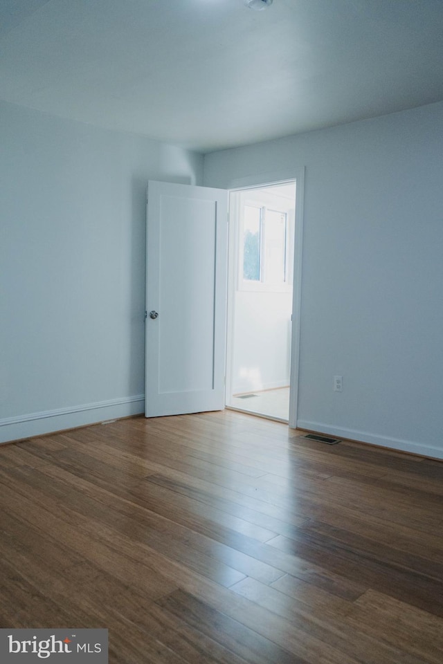 empty room with dark hardwood / wood-style floors