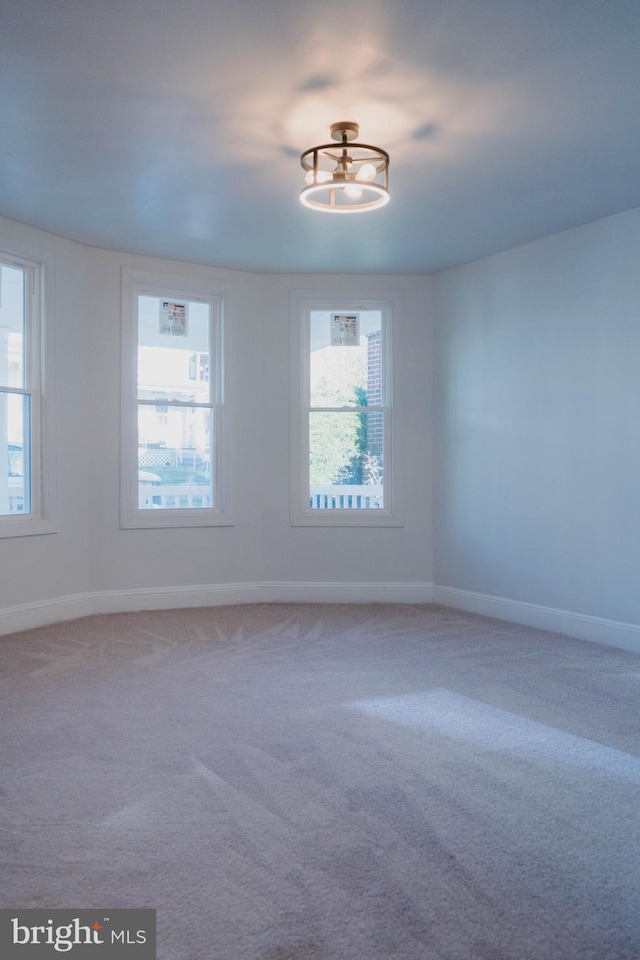 carpeted spare room with a healthy amount of sunlight