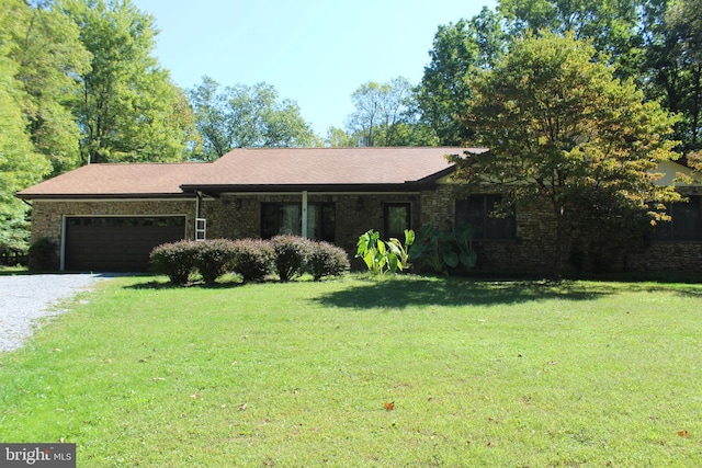 ranch-style home with a garage and a front yard