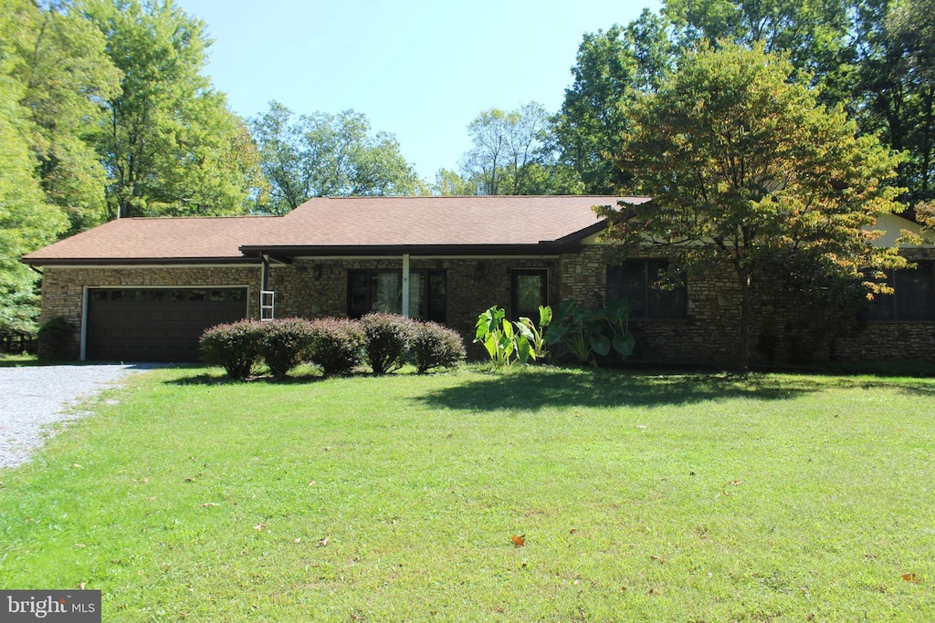 single story home with driveway, a front lawn, a garage, and a shingled roof